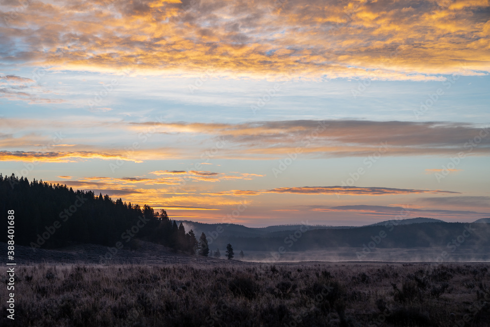 Colorful sunrise in Hayden Valley, with steam coming up from the Yellowstone River