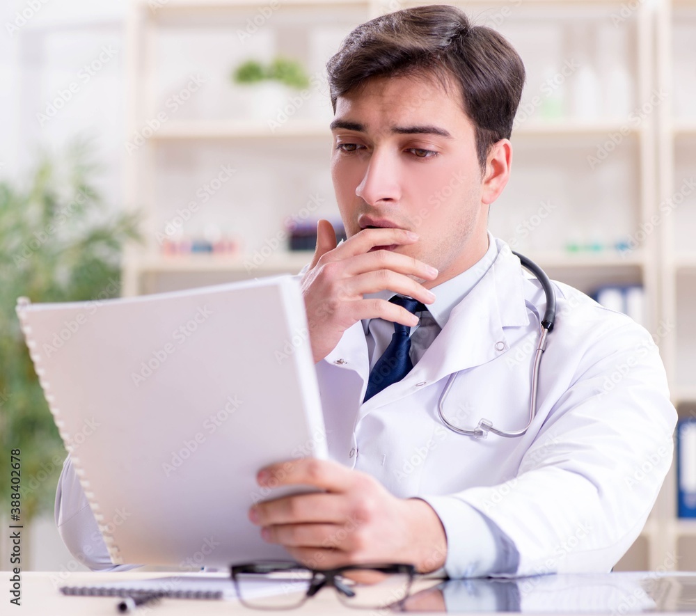 Young doctor sitting in the office Young doctor sitting in the office