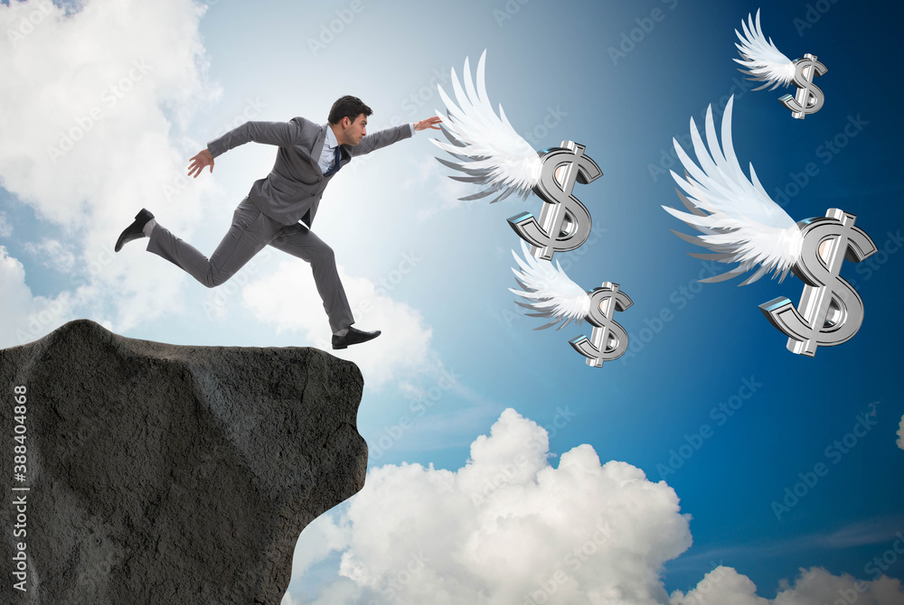 Businessman chasing angel dollars in business concept