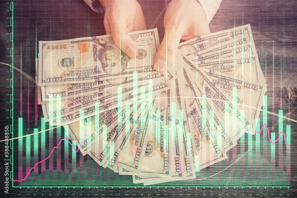 Multi exposure of financial graph drawing hologram and USA dollars bills and man hands. Analysis concept. Multi exposure of financial graph drawing hologram and USA dollars bills and man hands. Analysis concept.