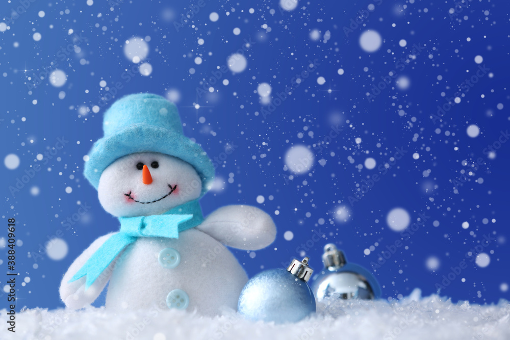 Cute snowman and Christmas balls on snow against blue background, bokeh effect. Space for text