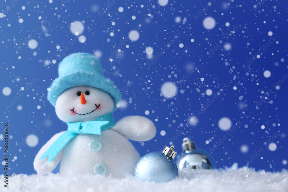 Cute snowman and Christmas balls on snow against blue background, bokeh effect. Space for text Cute snowman and Christmas balls on snow against blue background, bokeh effect. Space for text