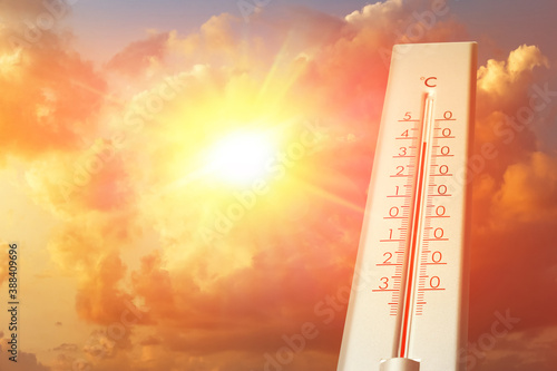 Weather thermometer showing high temperature and sunny sky with clouds on background
