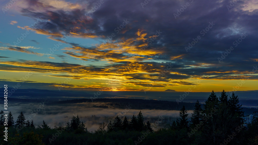 Fototapeta premium Dramatic sunrise over mist-covered Fraser Valley, BC - Autumn