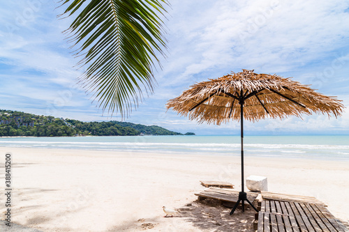 Beach Umbrella made of palm leafs on a perfect white beach in front of Sea, Thailand.