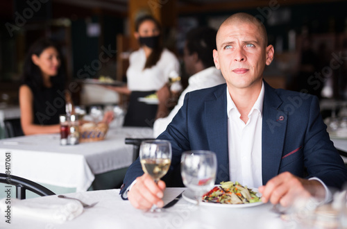 portrait of adult businessman sitting in restaurante