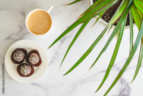 Coffee time. Cup of coffee  chocolate candy close up on marble table  flat lay with copy space