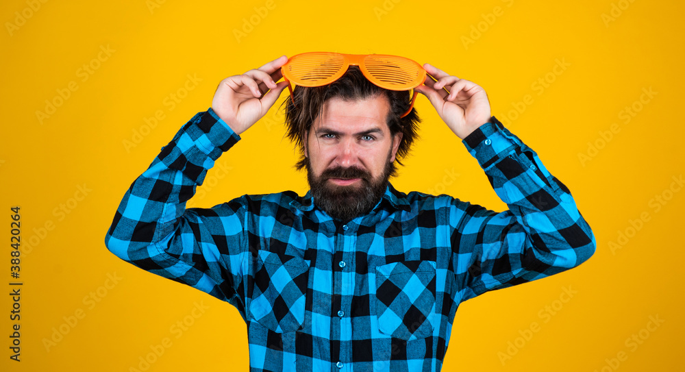 male with moustache having fun. handsome hipster party goer. serious mature man on yellow background. bearded man in funny glasses. brutal guy wear checkered shirt. concept of summer vacation male with moustache having fun. handsome hipster party goer. serious mature man on yellow background. bearded man in funny glasses. brutal guy wear checkered shirt. concept of summer vacation