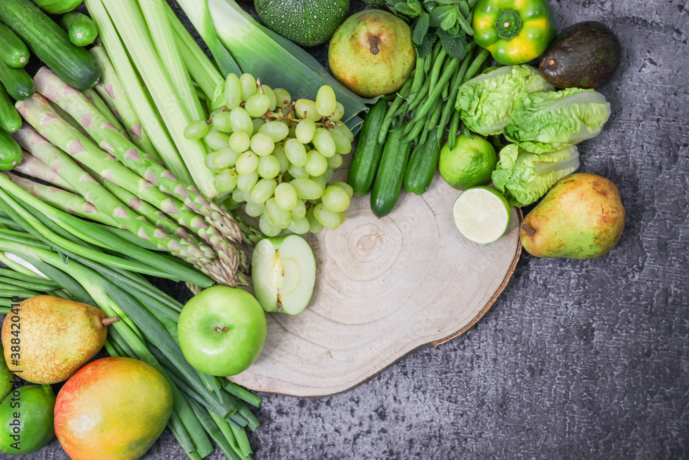 vegetables and fruits.
Green fruits and vegetables with a wooden board are arranged in a semicircle on the left with space for text on the right, a close-up top view. vegetables and fruits.
Green fruits and vegetables with a wooden board are arranged in a semicircle on the left with space for text on the right, a close-up top view.