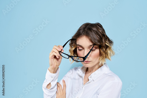 Business woman in a light shirt on a blue background gestures with her hands emotions model work