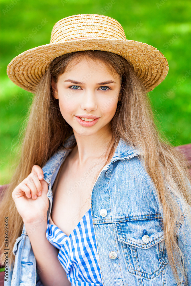 Portrait of a young model in a straw hat