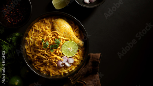 Northern Thai food, Noodles curry soup with Chicken (Khao Soi) serving in restaurant photo