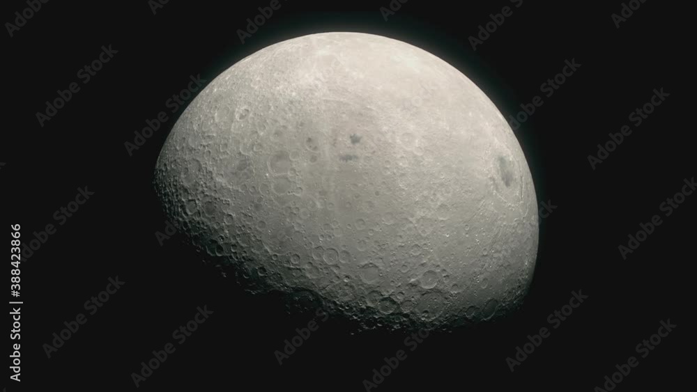 In the darkness of outer space the crater covered surface of the Moon can be seen slowly rotating In the darkness of outer space the crater covered surface of the Moon can be seen slowly rotating