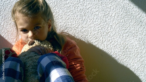 Mistreated child. Little girl on the floor sad. Child abuse concept.