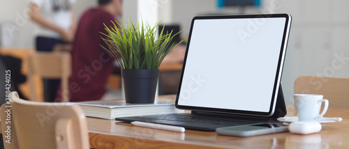 Portable workspace with digital tablet, smartphone, supplies and plant pot, clipping path