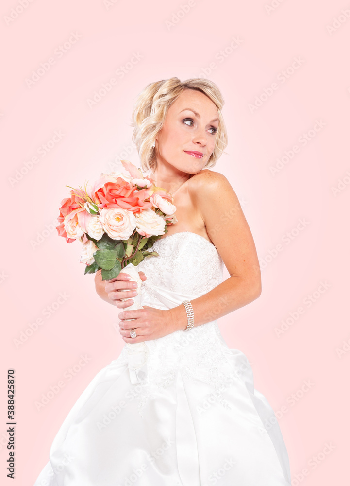 A beautiful blonde young bride isolated on pink background. A beautiful blonde young bride isolated on pink background.