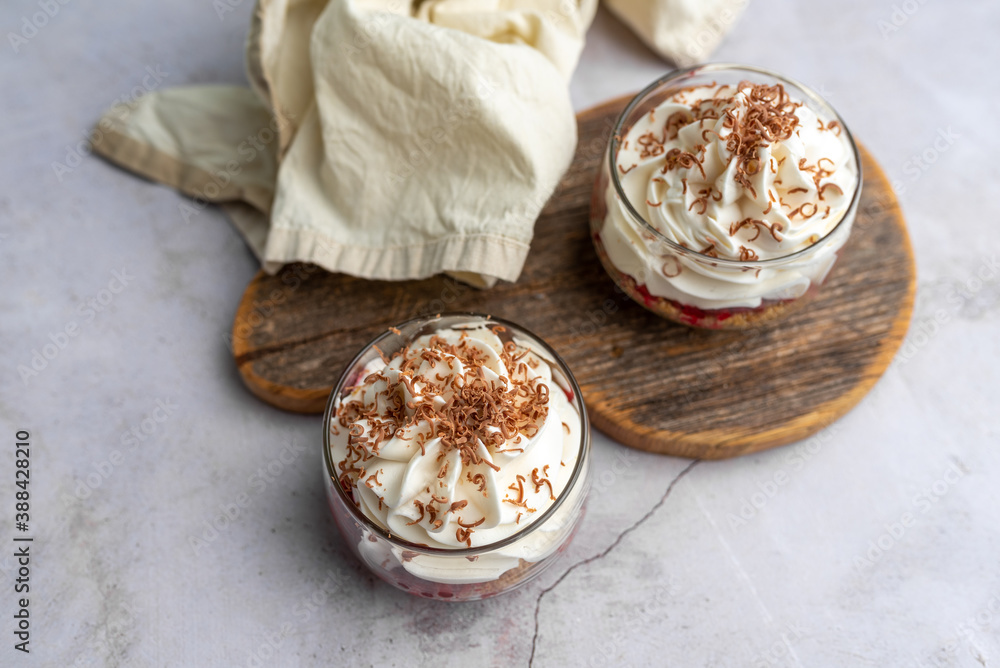 White Chocolate mousse dessert in a glass with raspberry and chocolate shavings White Chocolate mousse dessert in a glass with raspberry and chocolate shavings