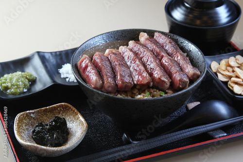 A piece of A5 Hida beef on top a rice bowl