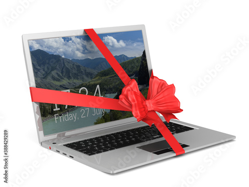 laptop with red bow on whit...