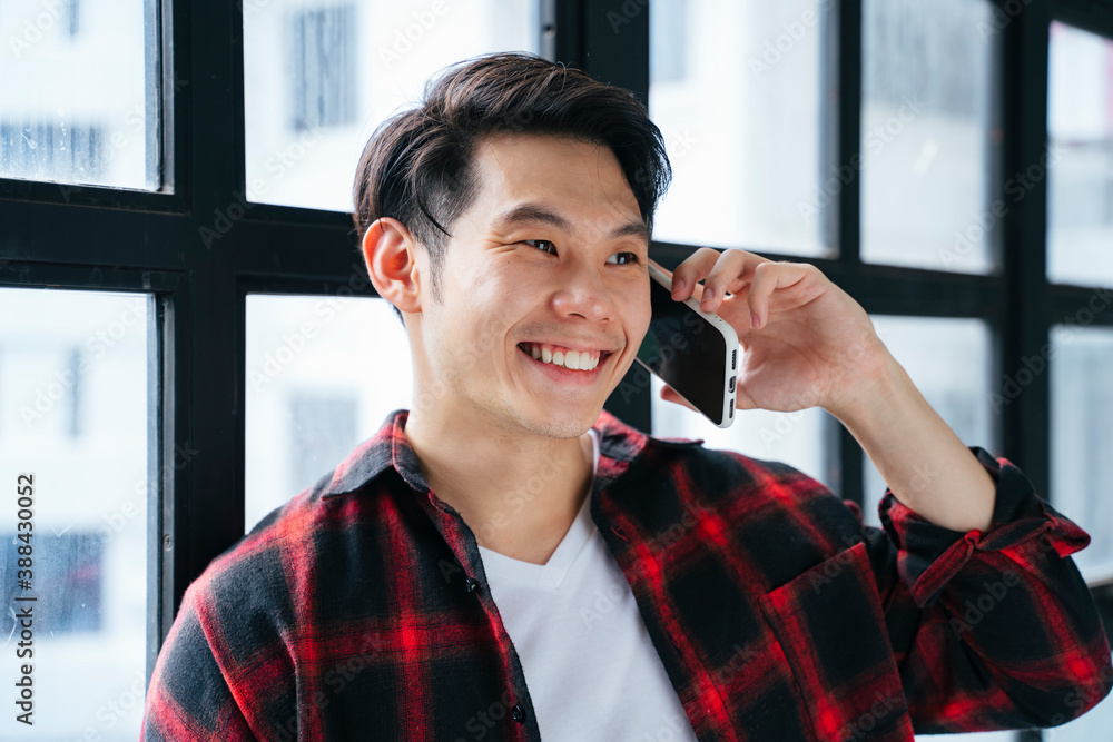 Young man using smartphone and smile. Young man using smartphone and smile.