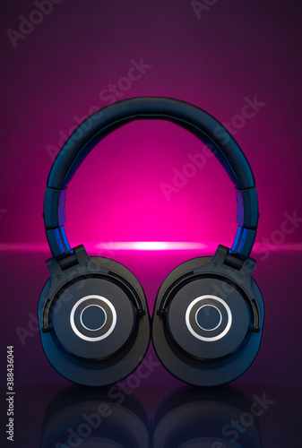 Gamer Headphones Dark Background and colorful pink Light.