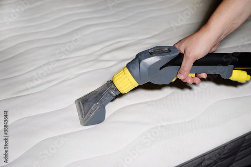 cleaning the mattress with a vacuum cleaner