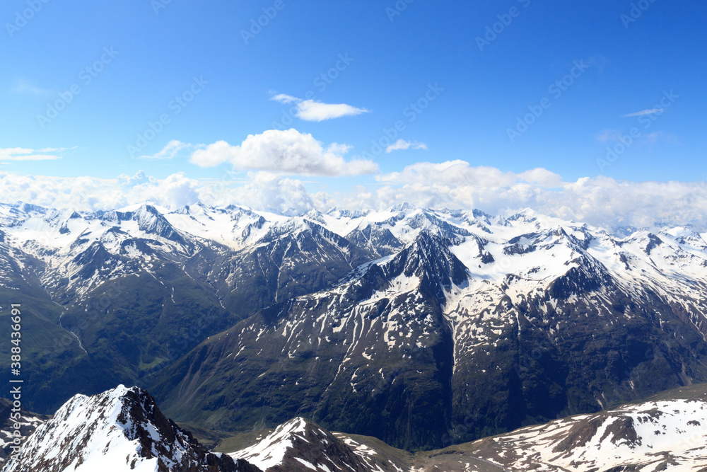 Mountain snow panorama on main chain of the Alps seen from summit Wildspitze and blue sky in Tyrol Alps, Austria