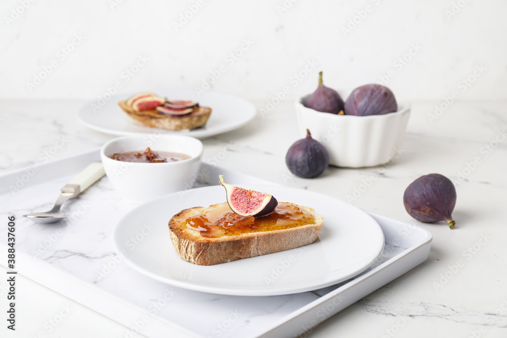 Plate with tasty sandwich with fig jam on table Plate with tasty sandwich with fig jam on table