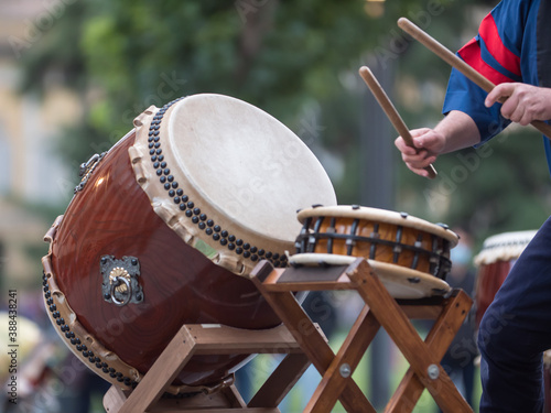 Man Playing Drums of Japanese Musical Tradition during a Public Outdoor Event photo