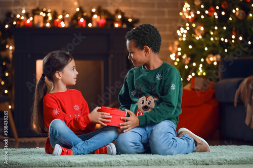 Cute children with gift at ...