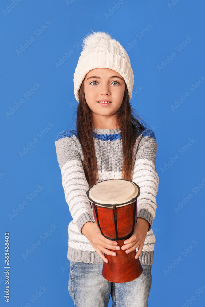 Little girl with drum on color background Little girl with drum on color background