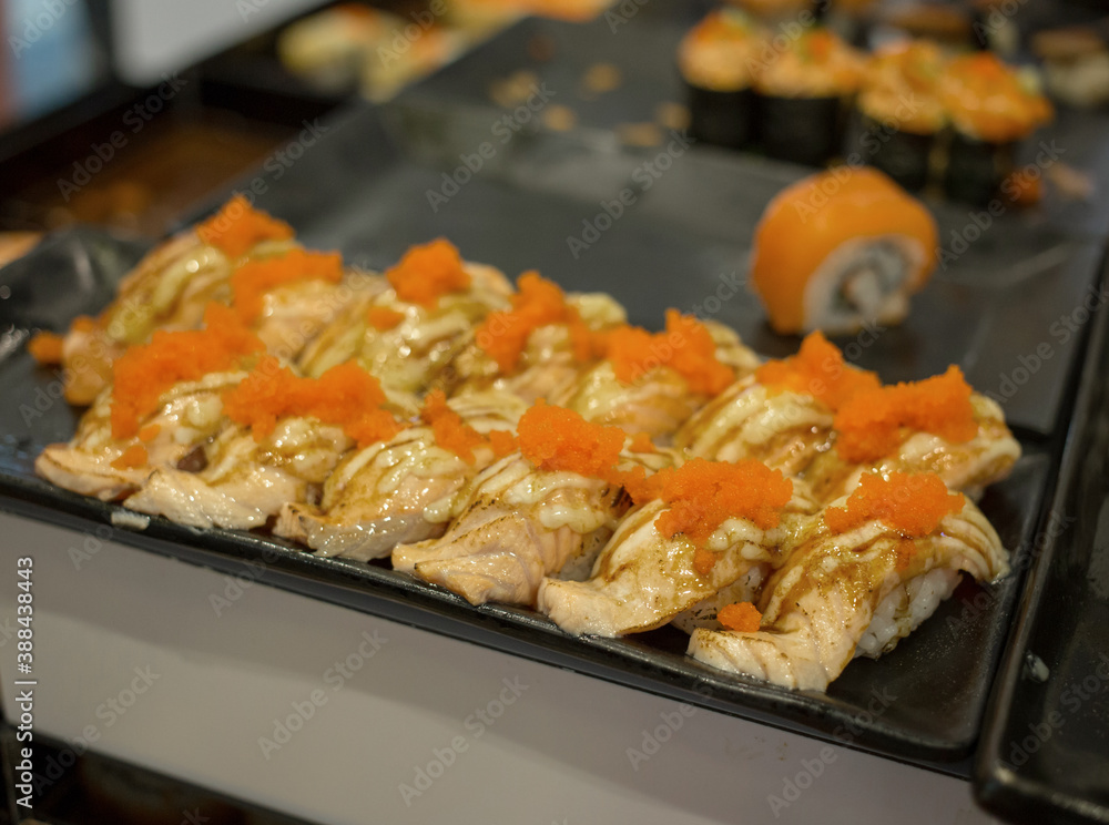 Japan food, Salmon Lava Roll in black plate, focus selective. Japan food, Salmon Lava Roll in black plate, focus selective.