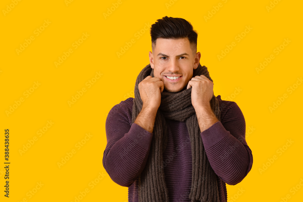 Handsome young man in winter clothes on color background Handsome young man in winter clothes on color background