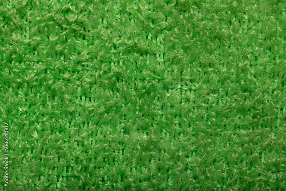 Light green fluffy background of thread. Terry fabric close-up. Light green fluffy background of thread. Terry fabric close-up.