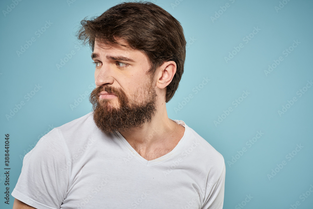 Fototapeta premium Bearded man emotions white t-shirt lifestyle gestures with hands blue backgrounds