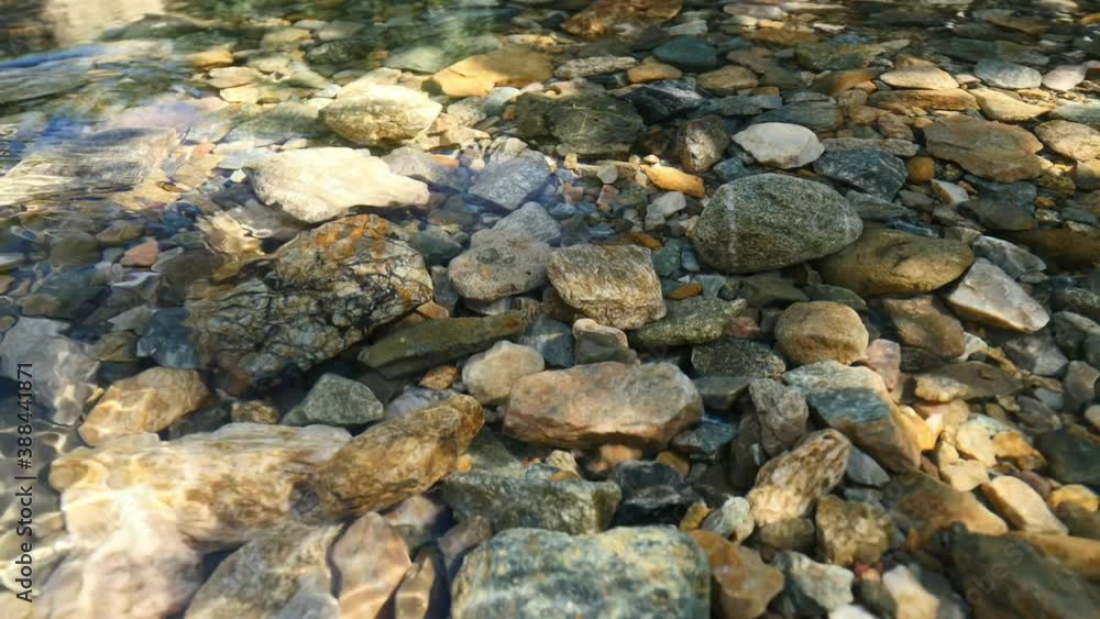 Clear river water and underwater pebble stones Clear river water and underwater pebble stones