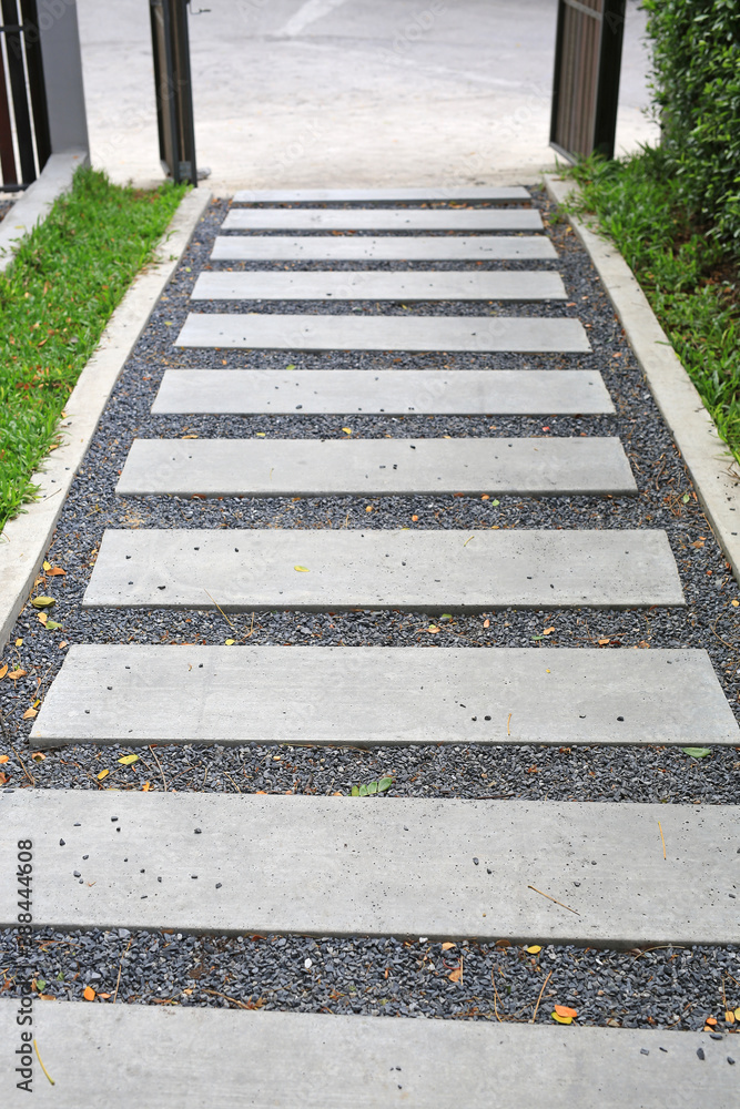 Obraz premium Cement stairs way in the garden to entrance door.