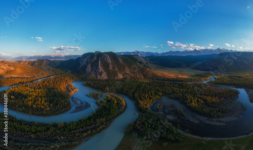 Kurai steppe and Chuya river on North-Chui ridge mountains background. Altai mountains, Russia. Aerial drone panoramic picture. © olinchuk