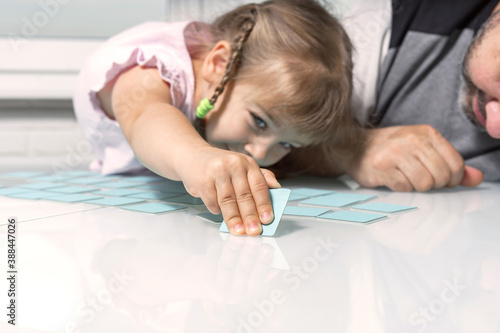 Memo cards for early childhood memory development/ dad and little daughter play together photo