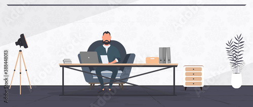 A businessman is working on a laptop in his office. Director's workplace. Laptop, documents, books, loft-style table. Vector.