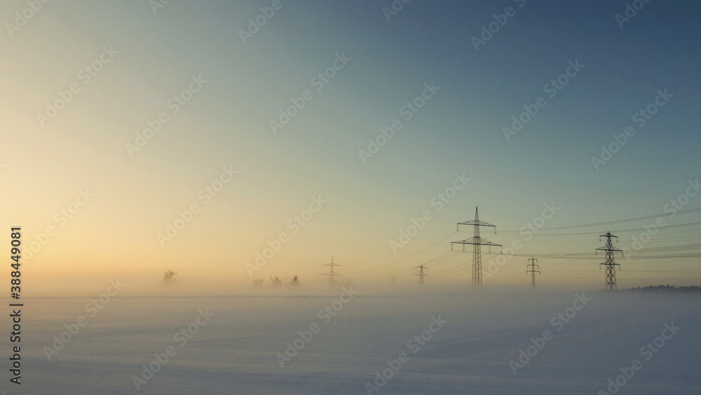 towers in snow with sunrise  