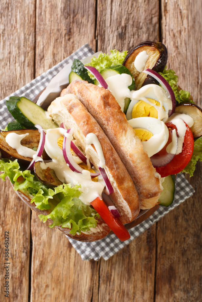 Jewish fast food sabich sandwich close-up on the table. Vertical top view from above Jewish fast food sabich sandwich close-up on the table. Vertical top view from above
