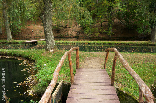 Wood bridge in park with ponds