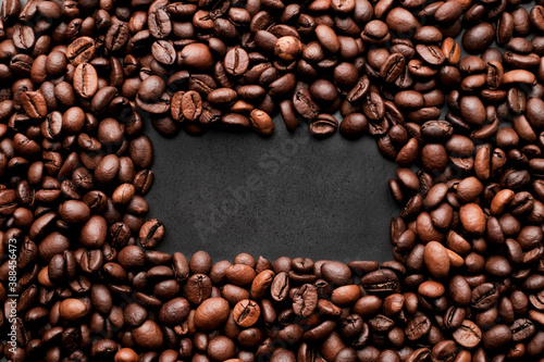 Coffee beans frames at dark gray background. Copy space 