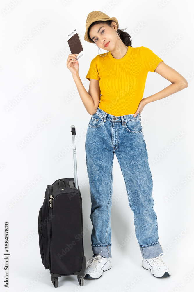 Attractive young Asian woman traveler holding passport and luggage over white isolated background. Ready for summer vacation