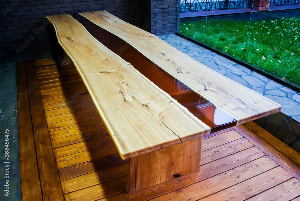 Large long wooden table with epoxy fill in the evening in a modern loft  style home interior. View from above Stock Photo | Adobe Stock