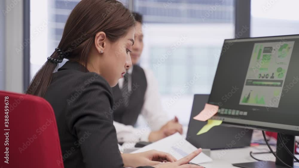 Group of Asian business people working in office, typing on computer. Group of Asian business people working in office, typing on computer.