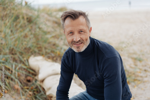Thoughtful senior man relaxing on a beach