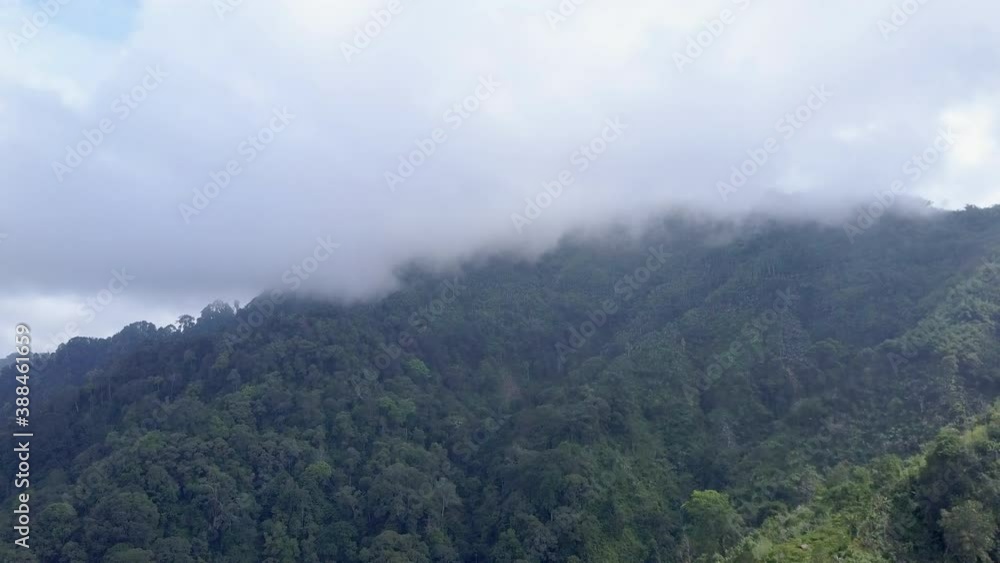 Flying towards a cloud covered mountain in Java, Indonesia. Flying towards a cloud covered mountain in Java, Indonesia.