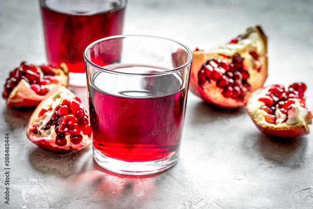 fresh pomegranate with juice in glasses on kitchen background fresh pomegranate with juice in glasses on kitchen background